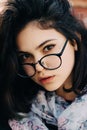 Beautiful happy hipster girl goes in the city. Closeup of trendy girl face. Royalty Free Stock Photo