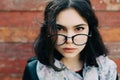 Beautiful happy hipster girl goes in the city. Closeup of trendy girl face. Royalty Free Stock Photo