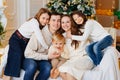 Beautiful happy large family on the couch by the Christmas tree. Royalty Free Stock Photo