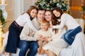 Beautiful happy large family on the couch by the Christmas tree. Royalty Free Stock Photo