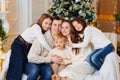 Beautiful happy large family on the couch by the Christmas tree. Royalty Free Stock Photo