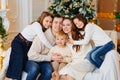 Beautiful happy large family on the couch by the Christmas tree. Royalty Free Stock Photo