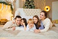 Beautiful happy large family on the floor in room with the Christmas tree. Royalty Free Stock Photo