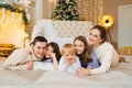 Beautiful happy large family on the floor in room with the Christmas tree. Royalty Free Stock Photo