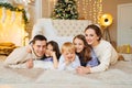 Beautiful happy large family on the floor in room with the Christmas tree. Royalty Free Stock Photo