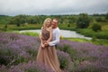 beautiful and happy laughing couple hugging in lavender field, blonde girl Royalty Free Stock Photo