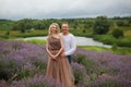 Beautiful and happy laughing couple hugging in lavender field, blonde girl Royalty Free Stock Photo