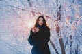 Beautiful happy laughing young woman wearing winter hat gloves covered with snow flakes. Royalty Free Stock Photo