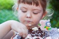 Beautiful happy little girl biting birthday cake Royalty Free Stock Photo