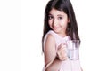 Beautiful happy little girl with long dark hair and dress holding glass of water. Royalty Free Stock Photo