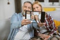 Happy mature couple taking selfie on tablet at home Royalty Free Stock Photo