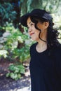 Middle-aged Japanese woman in black straw sun brim hat, summer park Royalty Free Stock Photo