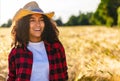 Happy Mixed Race African American Girl Teenager Young Woman Cowboy Hat in a field Royalty Free Stock Photo