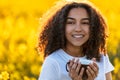 Mixed Race African American Teenager Woman Drinking Coffee In Yellow Flowers Royalty Free Stock Photo