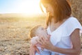 Beautiful happy mother breastfeeding her baby boy outdoor. Royalty Free Stock Photo