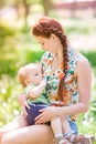 Beautiful happy mother breastfeeding outdoor Royalty Free Stock Photo