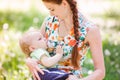 Beautiful happy mother breastfeeding outdoor Royalty Free Stock Photo