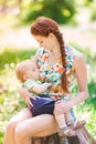 Beautiful happy mother breastfeeding outdoor Royalty Free Stock Photo