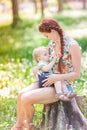 Beautiful happy mother breastfeeding outdoor Royalty Free Stock Photo