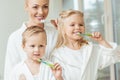 kids with mother brushing teeth