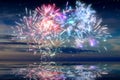 Beautiful happy new year fireworks in the sky with reflections on water Royalty Free Stock Photo