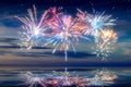 Beautiful happy new year fireworks in the sky with reflections on water Royalty Free Stock Photo