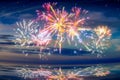 Beautiful happy new year fireworks in the sky with reflections on water Royalty Free Stock Photo