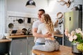 Pair of lovers hugging in kitchen
