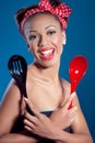 Beautiful happy pinup style housewife with kitchen Royalty Free Stock Photo