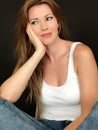 Beautiful Happy Relaxed Young Woman Smiling Sitting in a Chair Royalty Free Stock Photo