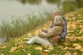 Beautiful happy senior couple relaxing in park with autumn leaves Royalty Free Stock Photo