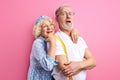 beautiful happy senior couple stand posing together isolated on pink background Royalty Free Stock Photo