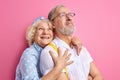 beautiful happy senior couple stand posing together isolated on pink background Royalty Free Stock Photo