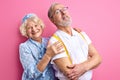 beautiful happy senior couple stand posing together isolated on pink background Royalty Free Stock Photo