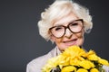 beautiful happy senior lady with yellow flowers, Royalty Free Stock Photo