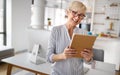 Beautiful happy senior woman using tablet computer at home Royalty Free Stock Photo