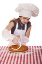 Beautiful happy seven year old girl in chef uniform with shortca Royalty Free Stock Photo