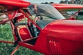 Beautiful happy sexy girl tourist pilot with headset and in cabin of little plane Royalty Free Stock Photo