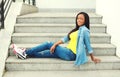 Beautiful happy smiling african woman wearing jeans clothes sitting Royalty Free Stock Photo