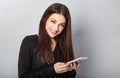 Beautiful happy smiling brunette woman of caucasian in black style shirt holding in hand and use mobile cell phone with blank Royalty Free Stock Photo