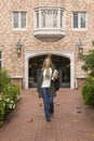 Beautiful, happy, smiling, confident female woman college university student walking on school campus Royalty Free Stock Photo