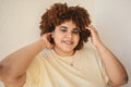 Beautiful happy smiling curvy plus size African black woman afro hair with make up posing in beige t-shirt on white