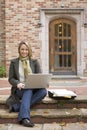Beautiful, happy, smiling, female woman college university student studying using laptop computer on campus Royalty Free Stock Photo