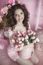 Beautiful happy smiling girl with curly hair, teen with flowers Royalty Free Stock Photo