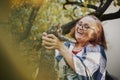 Beautiful happy smiling senior woman in eyeglasses holding little kitten in her garden Royalty Free Stock Photo