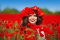 Beautiful happy smiling teen girl portrait with red flowers on h Royalty Free Stock Photo