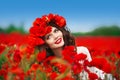 Beautiful happy smiling teen girl portrait with red flowers on h Royalty Free Stock Photo