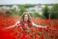 Beautiful happy smiling teen girl portrait with red flowers on head enjoying in poppies field nature background. Makeup Royalty Free Stock Photo