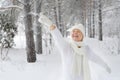 Beautiful, happy, smiling woman points a finger, gloved.