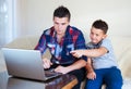 Beautiful happy two brothers buying online Royalty Free Stock Photo